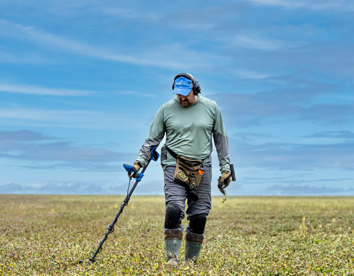 A man hunting in a field with a Vortex